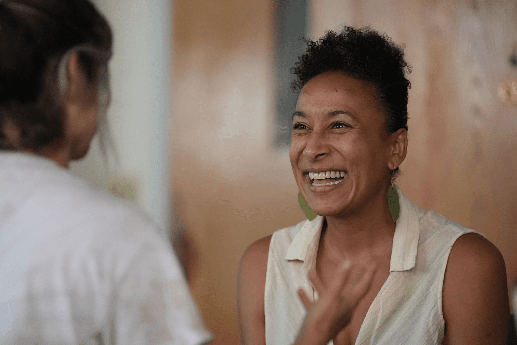 A woman laughing warmly in conversation during a Sleepawake immersive