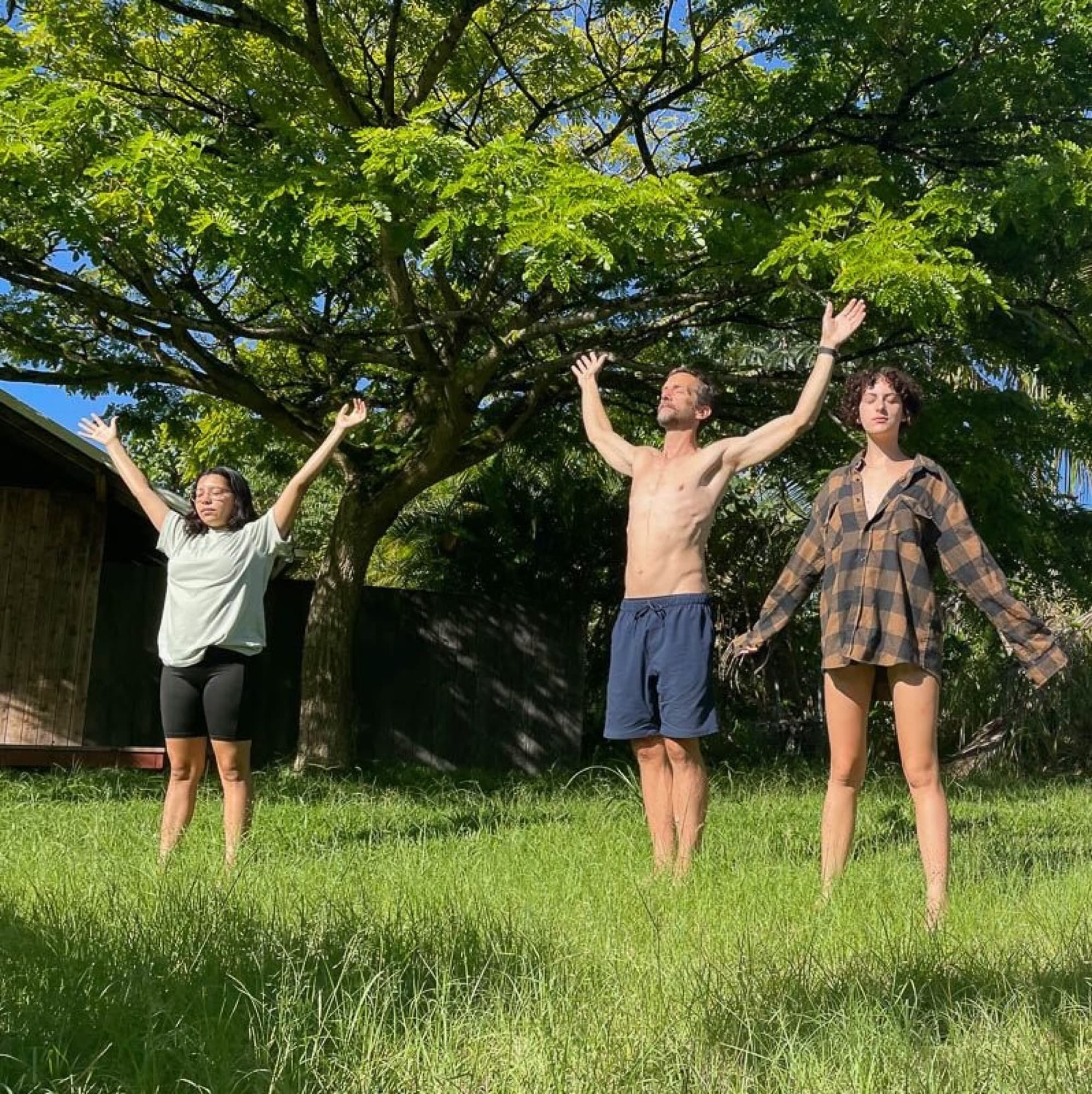 Campers with arms raised in an open field